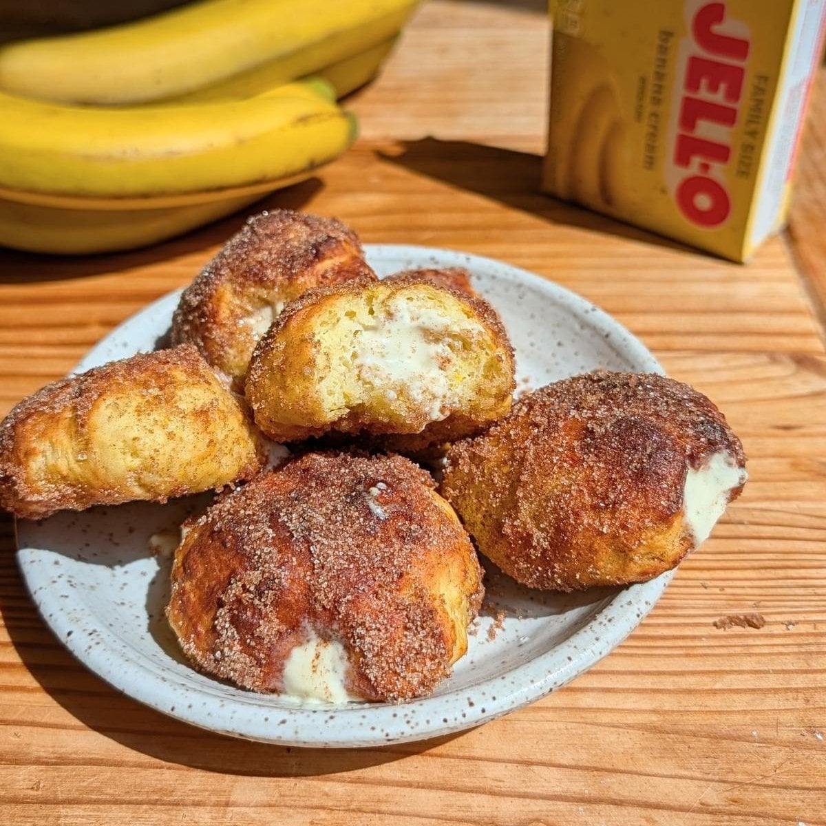 A bite taken out of one of the banana donuts.