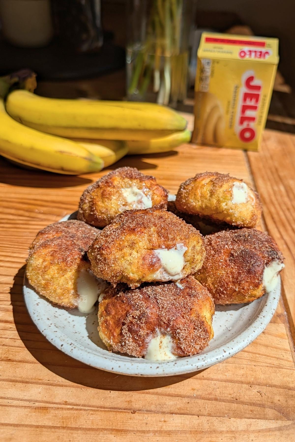 A plate of banana pudding donuts stacked.
