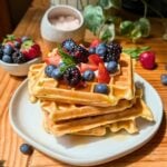 A stack of cottage cheese waffles with berries on top.