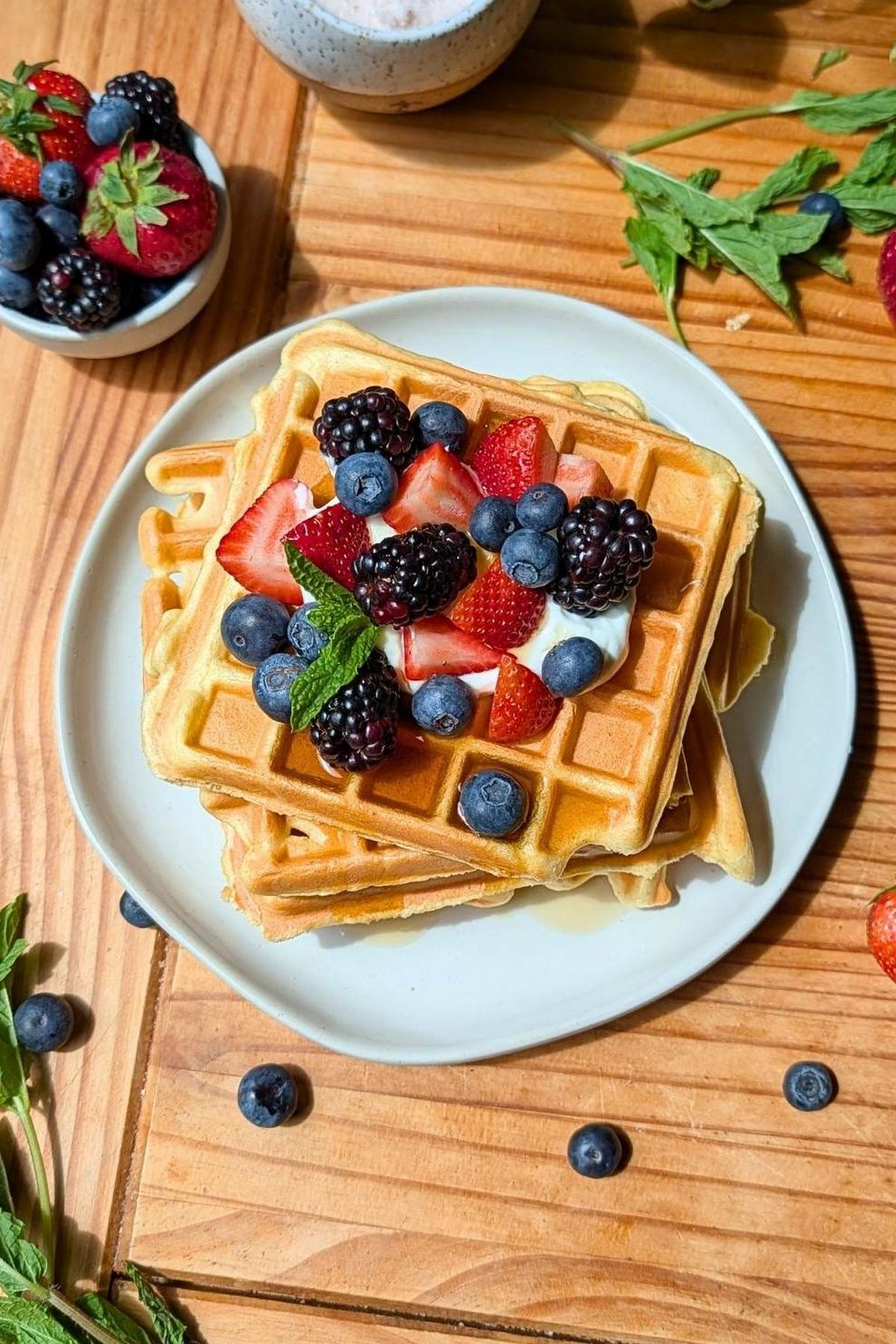 A stack of cottage cheese waffles with berries on top.