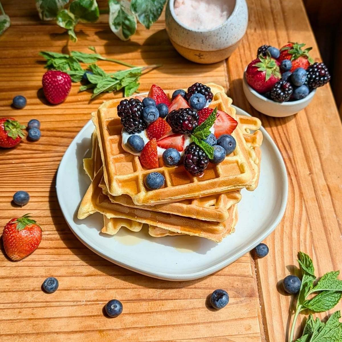 A stack of cottage cheese waffles with berries on top.