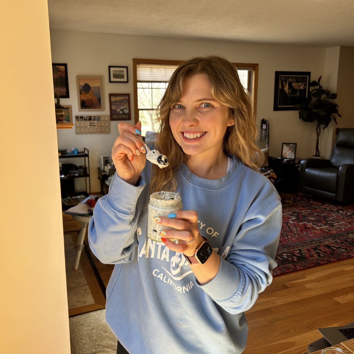 Mika holding greek yogurt chia seed puding.