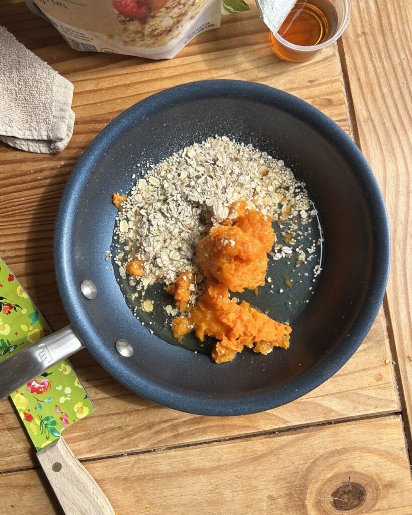 A skillet with oats, egg whites, and mashed sweet potato.
