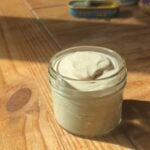 A container with greek yogurt caesar dressing.