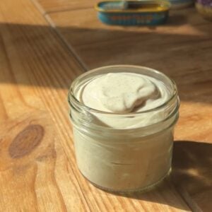 A container with greek yogurt caesar dressing.