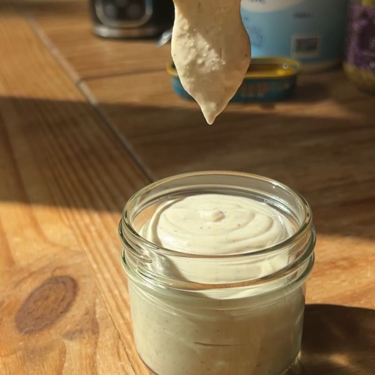 Pouring the dressing into the cup.