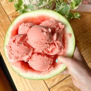 Watermelon sorbet scoops in an empty watermelon rind.