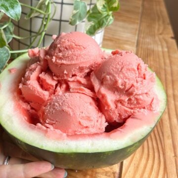 Watermelon sorbet scoops in an empty watermelon rind.
