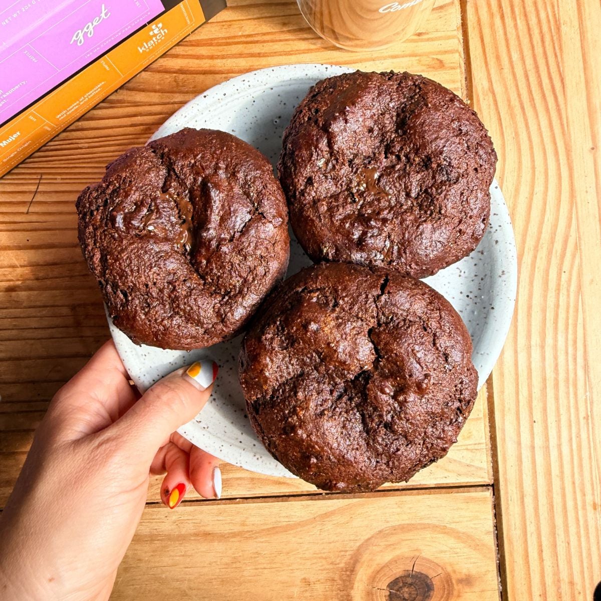 A plate of 3 protein chocolate chunk muffins.