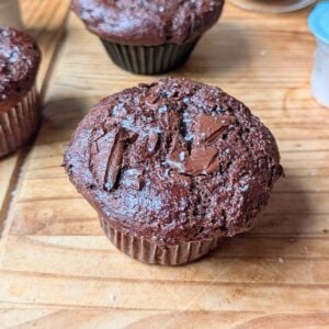 A chocolate chunk muffin on a table.