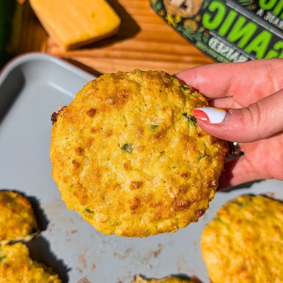 A hand holding a jalapeno cheddar scone.