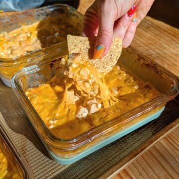 Buffalo chicken dip being pulled out of a container.