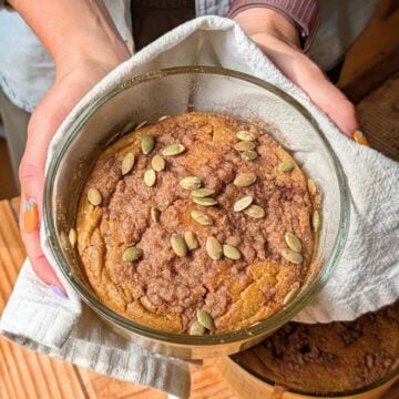 Hands holding pumpkin pancakes.