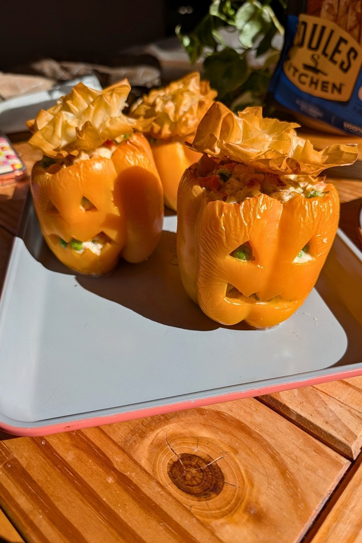 An orange bell pepper stuffed with chicken pot pie filling.