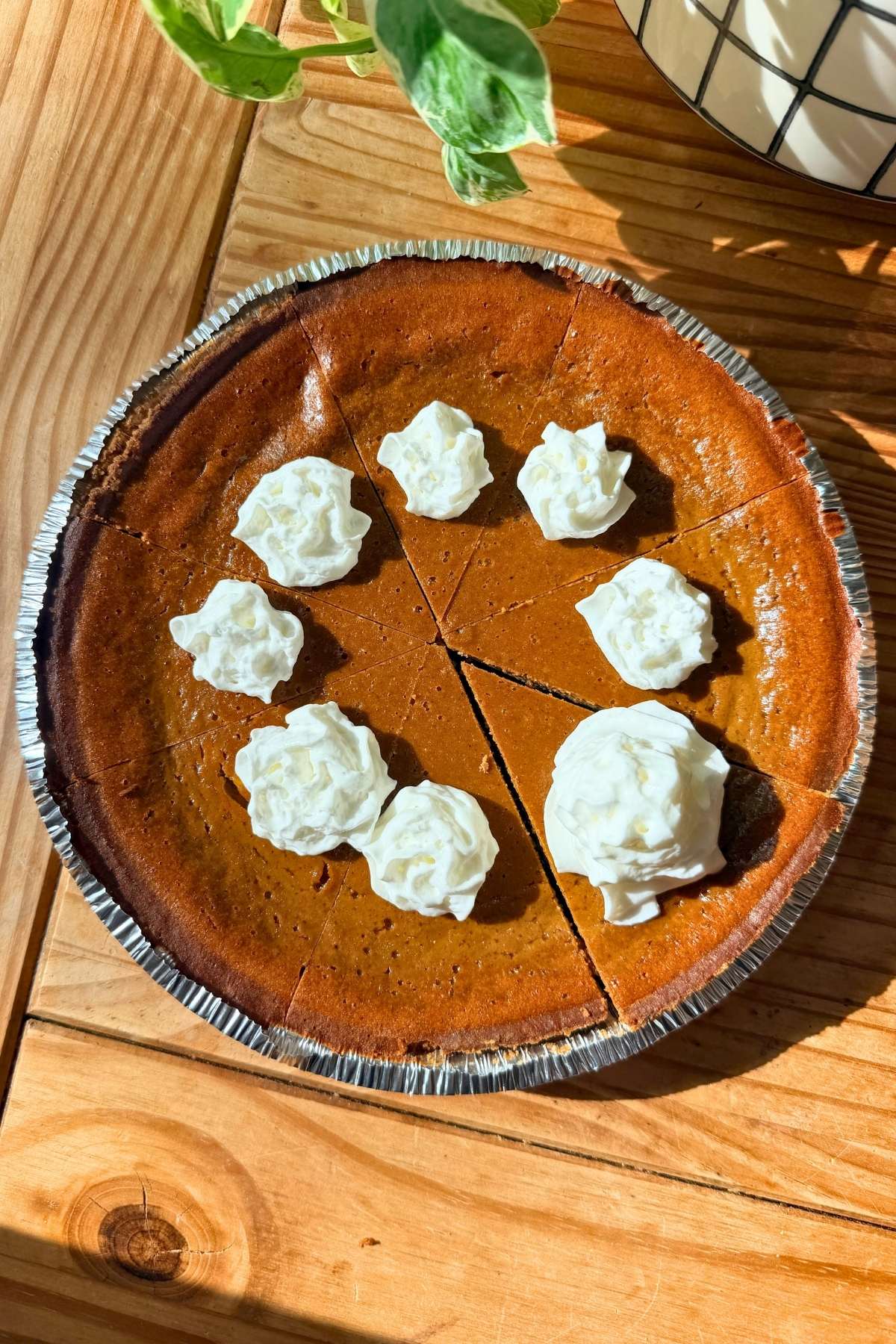 A cottage cheese pumpkin pie with whipped cream on each piece.