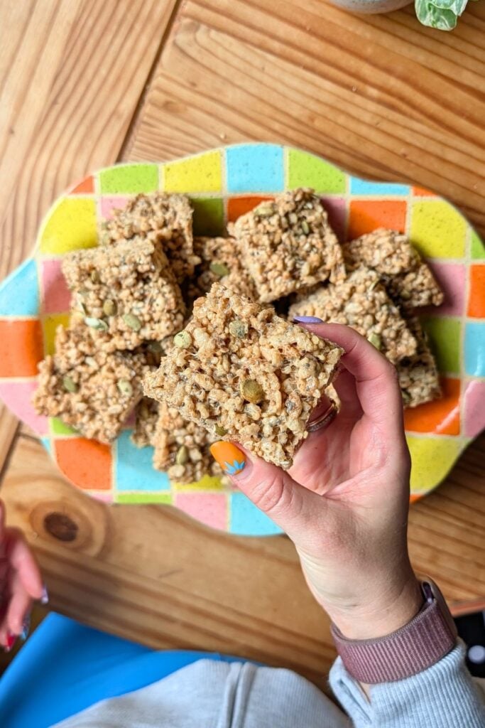 A hand holding a fall fiber rice krispie treat.