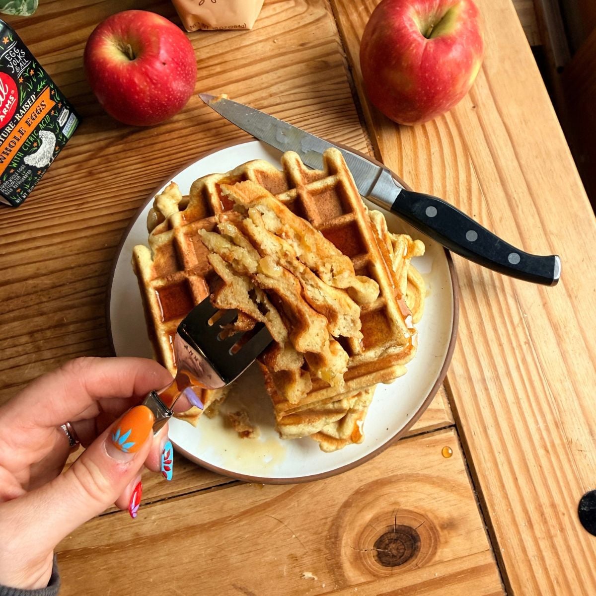 A fork holding cut up apple protein waffles.